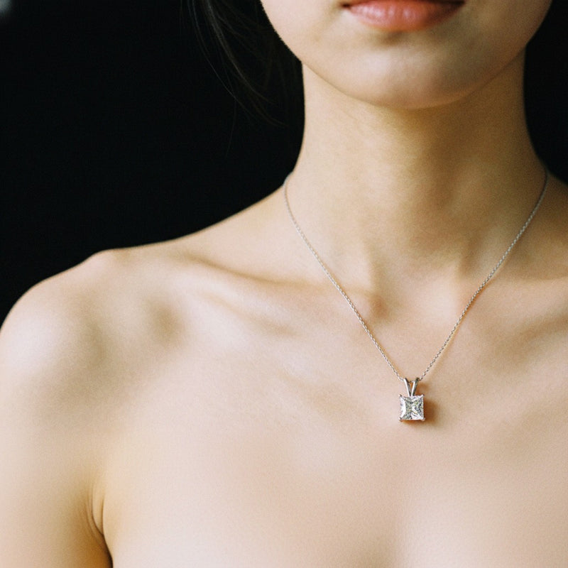Model wearing princess split bale solitaire pendant