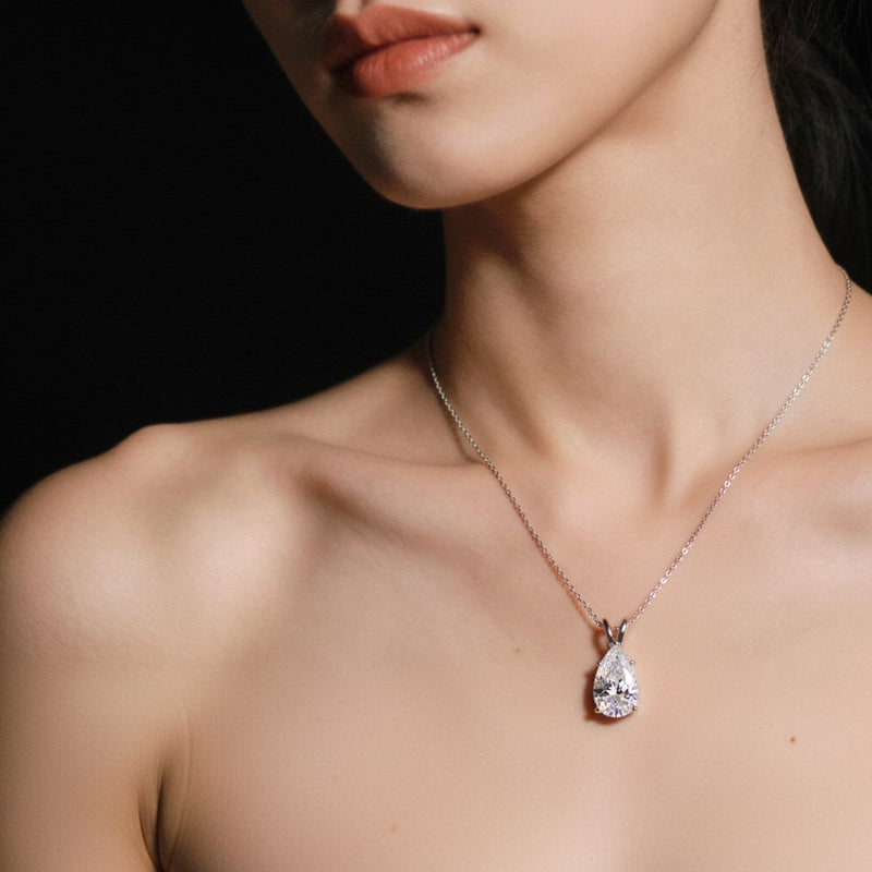 Model wearing pear split bale solitaire pendant