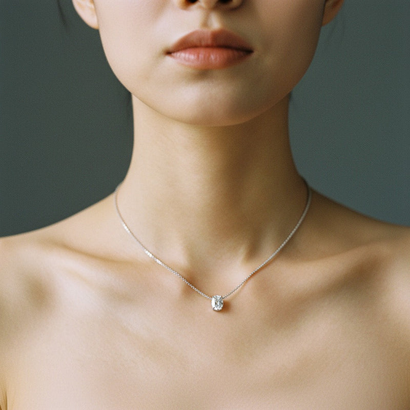Model wearing cushion east west solitaire necklace