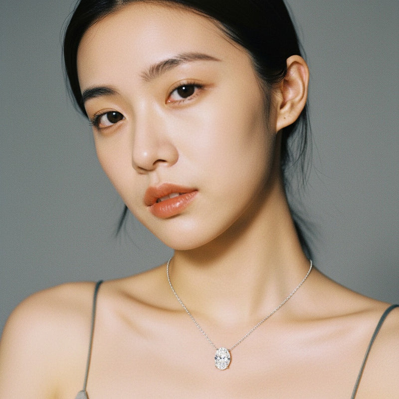 Model wearing oval east west solitaire necklace