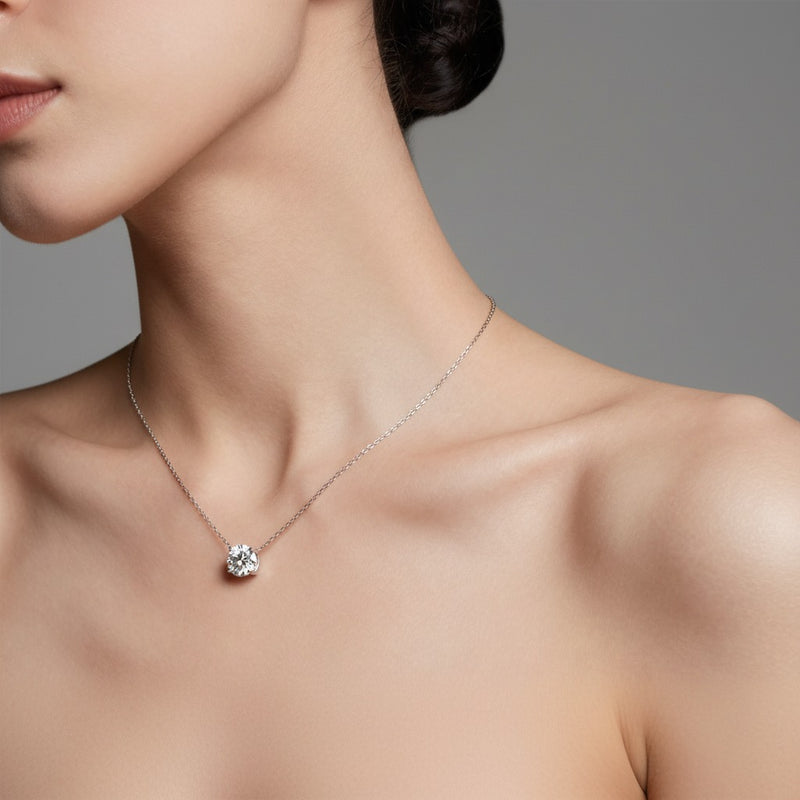 Model wearing round solitaire necklace