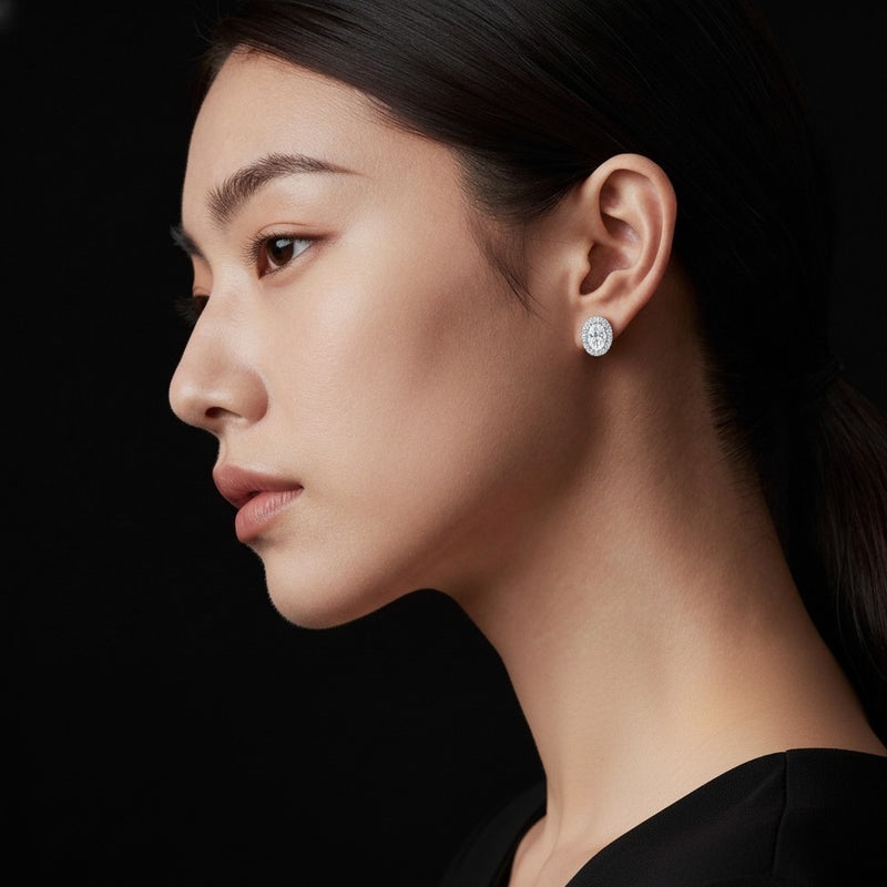 Model wearing oval halo stud earrings