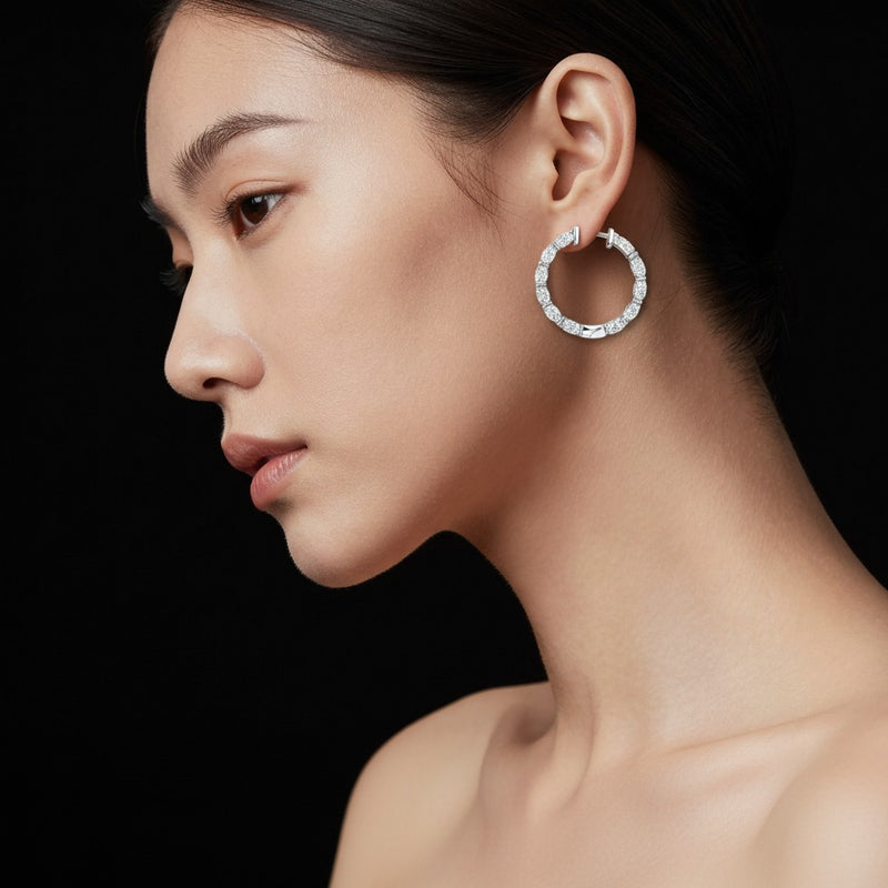 Model wearing oval inside out hoop earrings