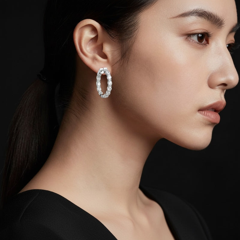 Model wearing oval inside out hoop earrings