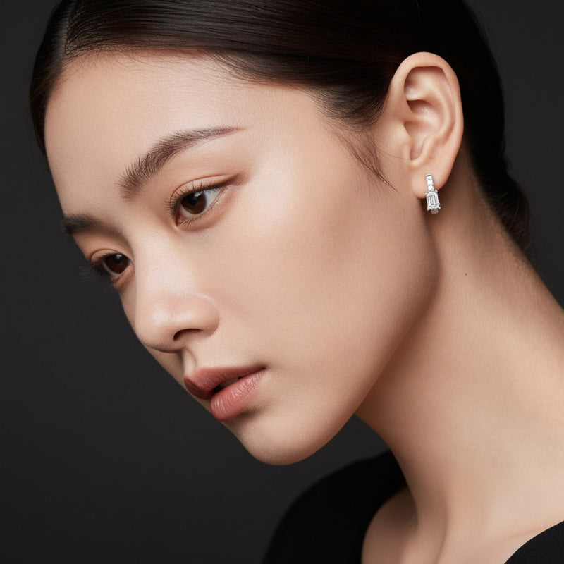 Model wearing emerald solitare accent huggie earrings