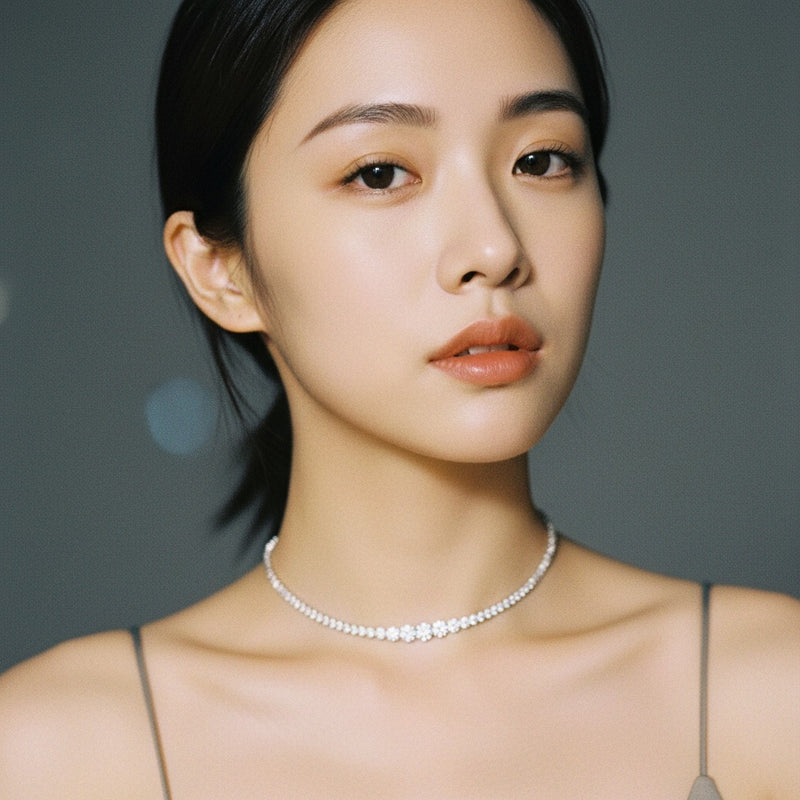 Model wearing round graduating half riviera necklace