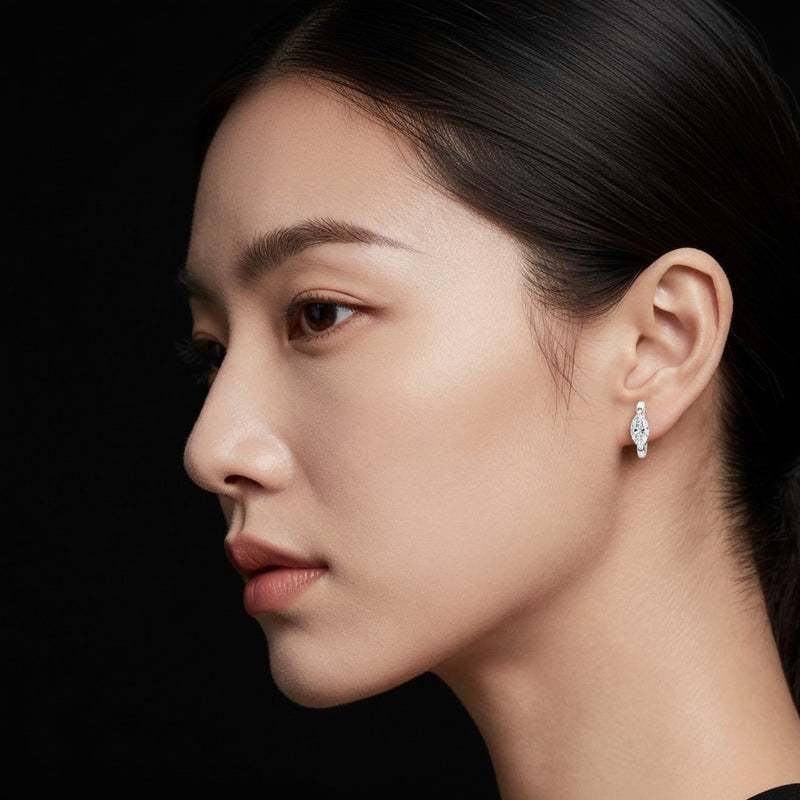 Model wearing marquise solitaire huggie earrings