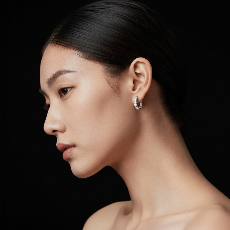 Model wearing round inside out hoop earrings
