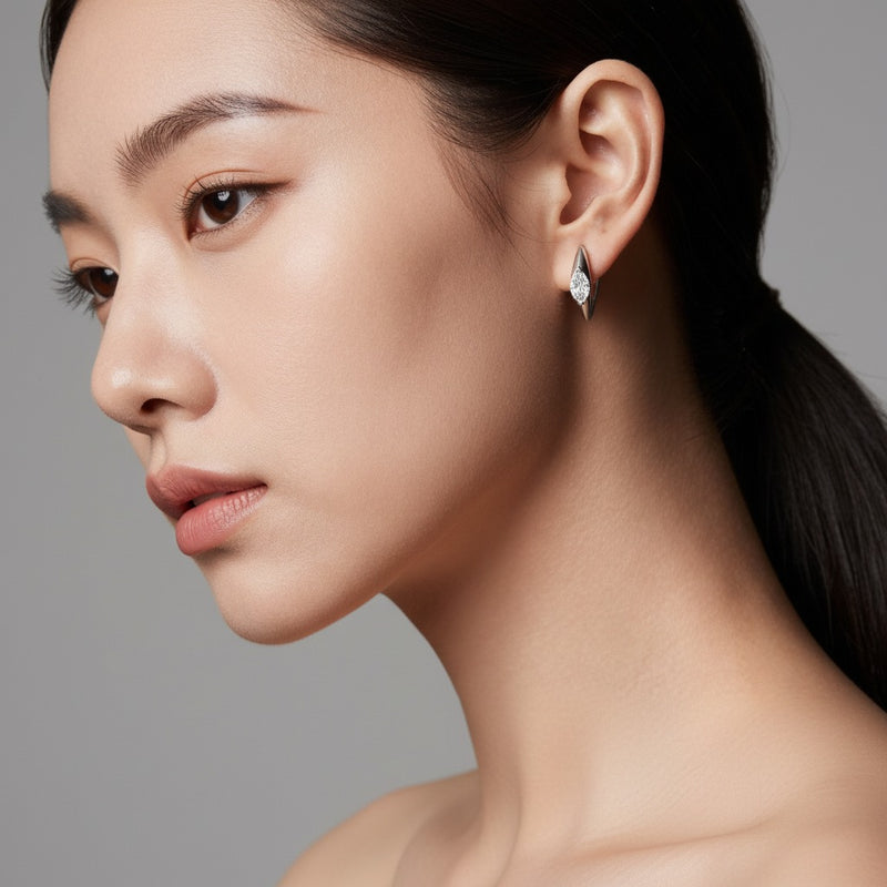 Model wearing marquise solitaire huggie earrings