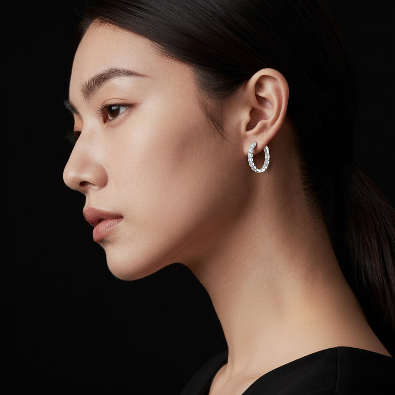 Model wearing round inside out hoop earrings