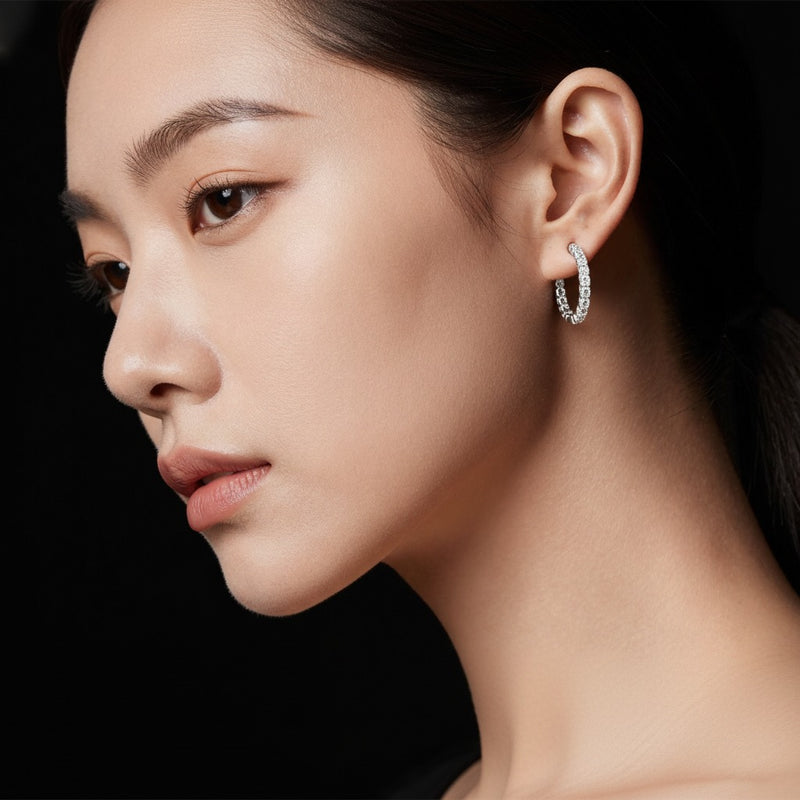 Model wearing round inside out hoop earrings
