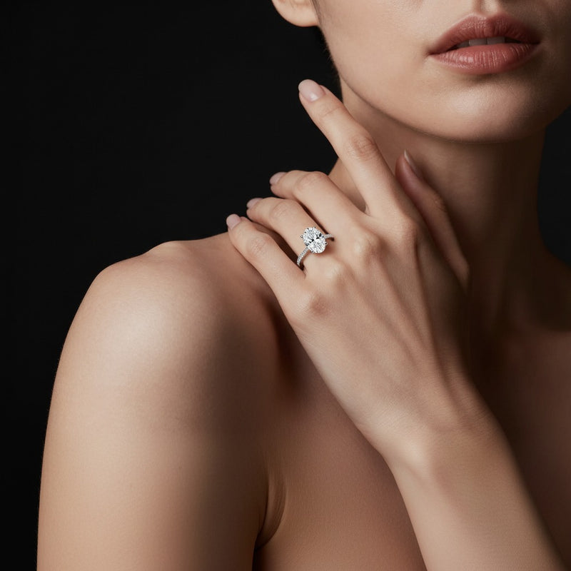 Model wearing oval accented engagement ring