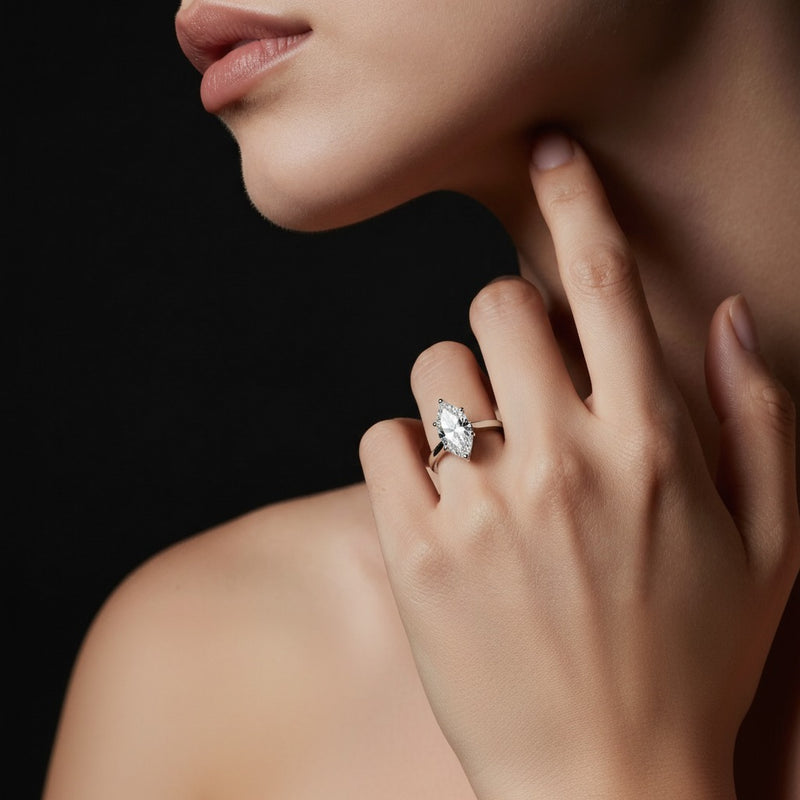 Model wearing marquise plain cathedral trellis shank solitaire engagement ring