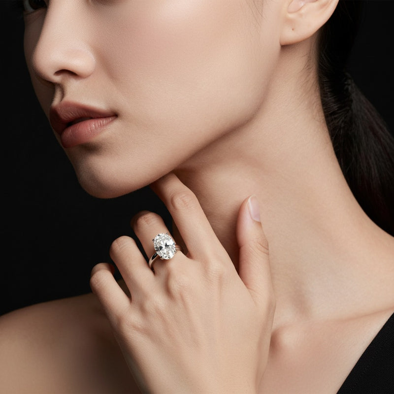 Model wearing oval plain cathedral trellis shank solitaire engagement ring