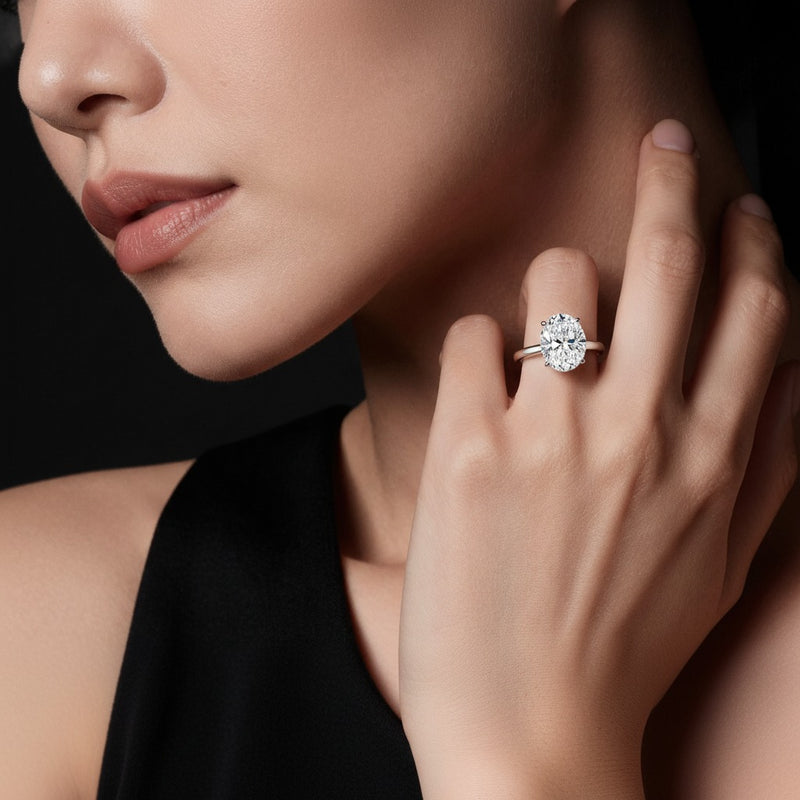 Model wearing oval plain cathedral trellis shank solitaire engagement ring