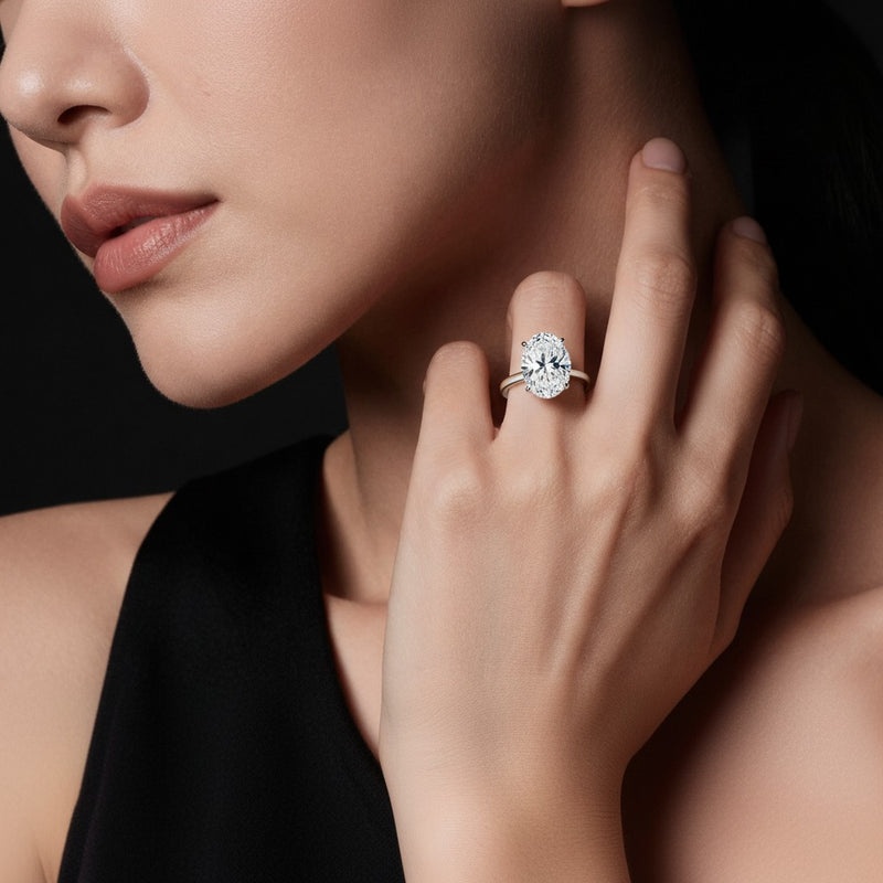 Model wearing oval plain cathedral trellis shank solitaire engagement ring