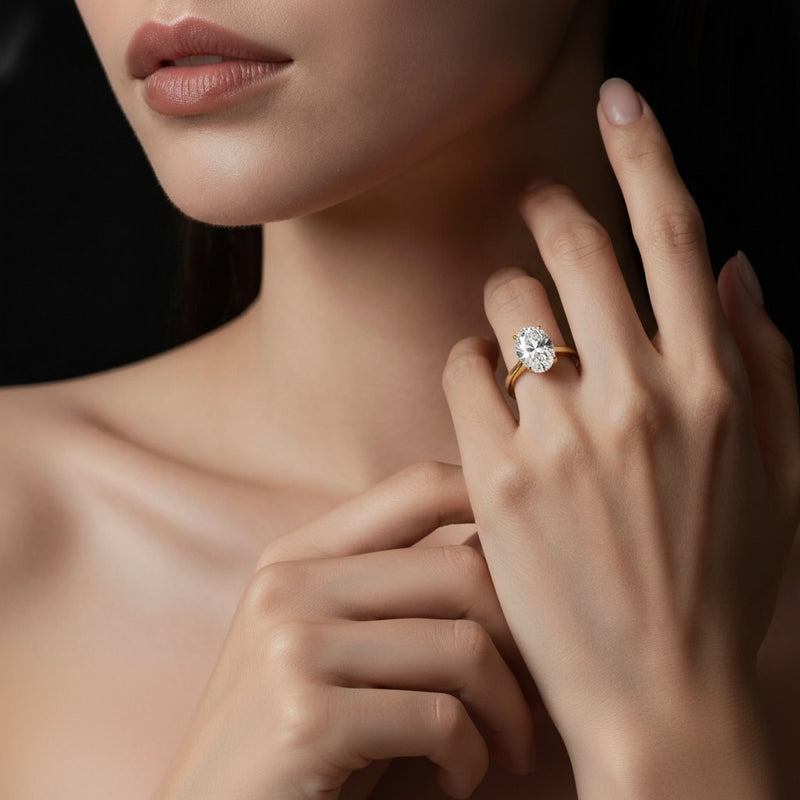 Model wearing oval plain cathedral trellis shank solitaire engagement ring