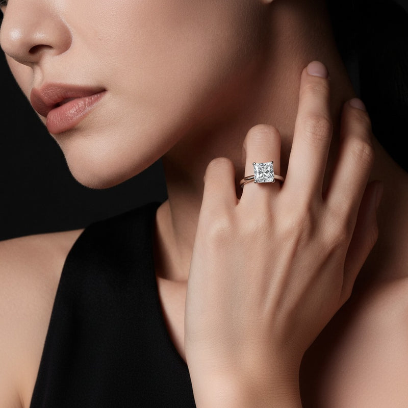 Model wearing princess plain cathedral trellis shank solitaire engagement ring