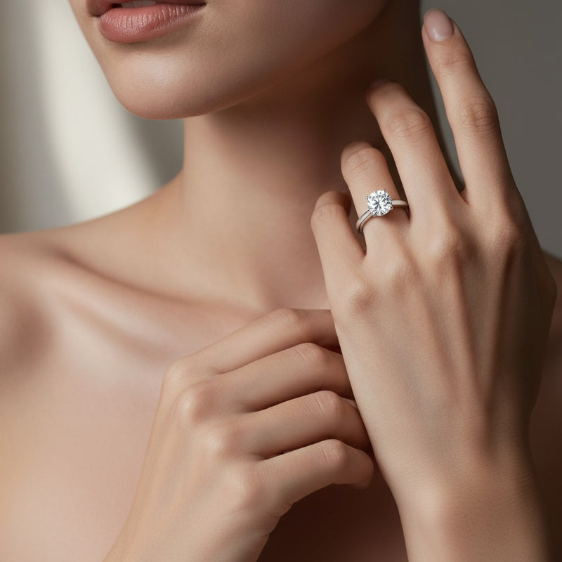 Model wearing round plain cathedral trellis shank solitaire engagement ring