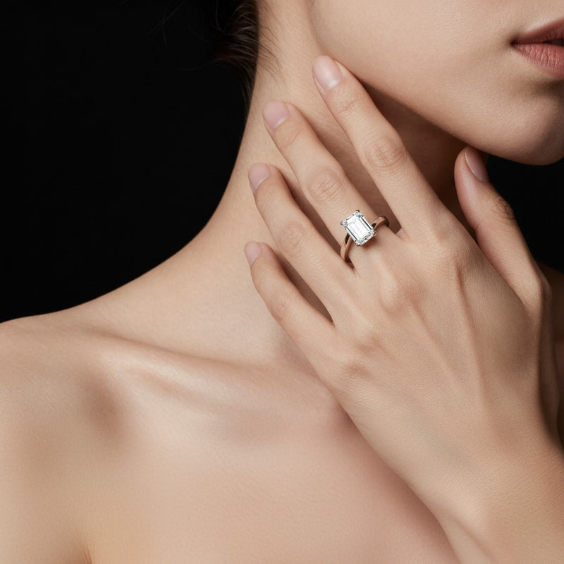 Model wearing emerald bypass shank engagement ring