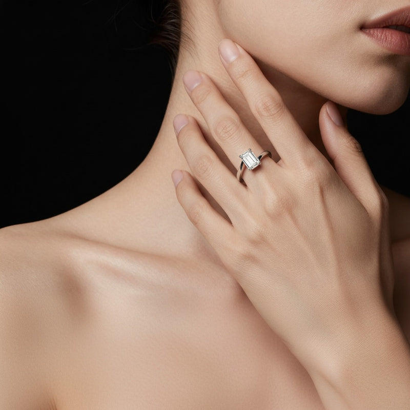 Model wearing emerald bypass shank engagement ring