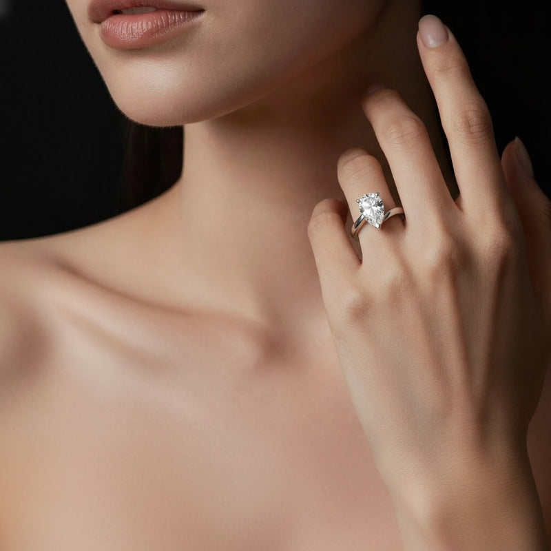 Model wearing pear bypass shank engagement ring