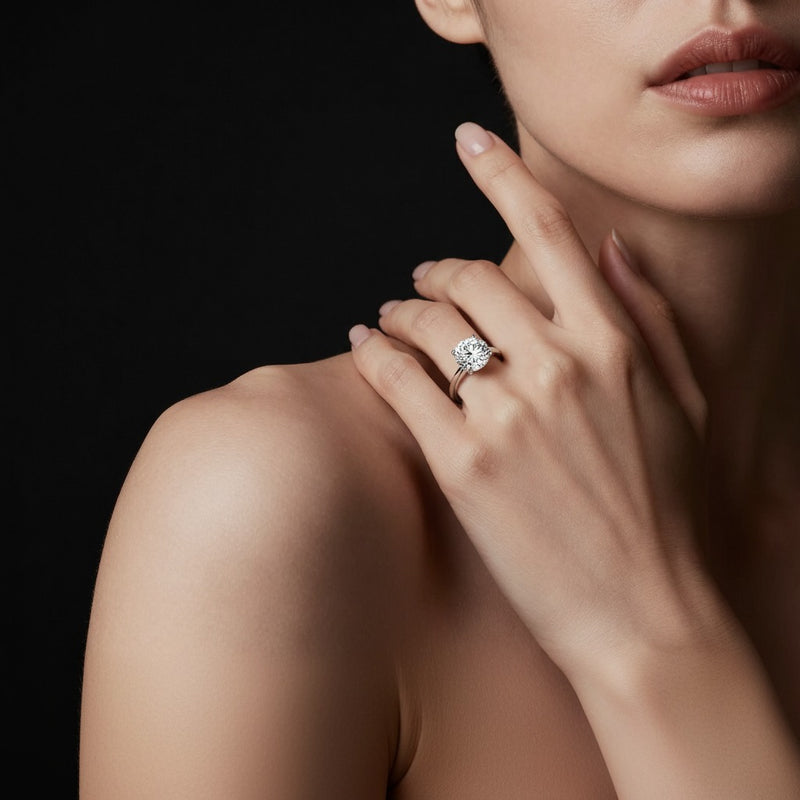 Model wearing round hidden halo cathedral shank engagement ring