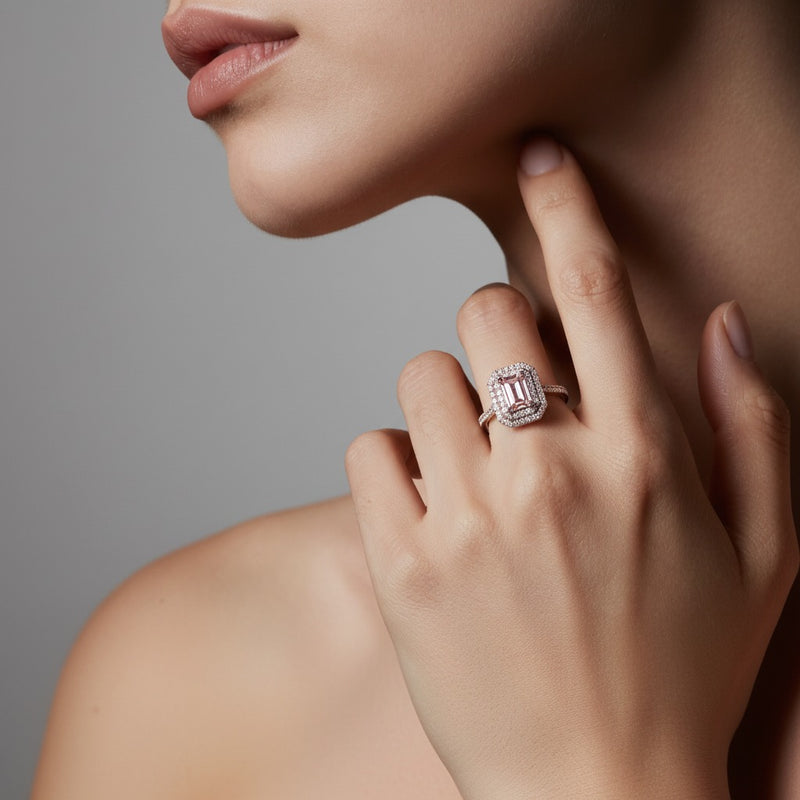 Model wearing emerald double halo engagement ring