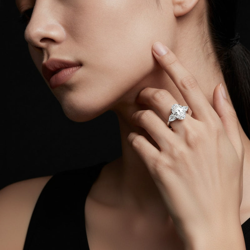 Model wearing oval three stone hidden halo ring