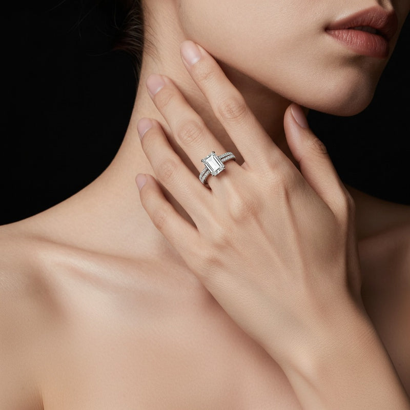 Model wearing emerald hidden halo accented engagement ring