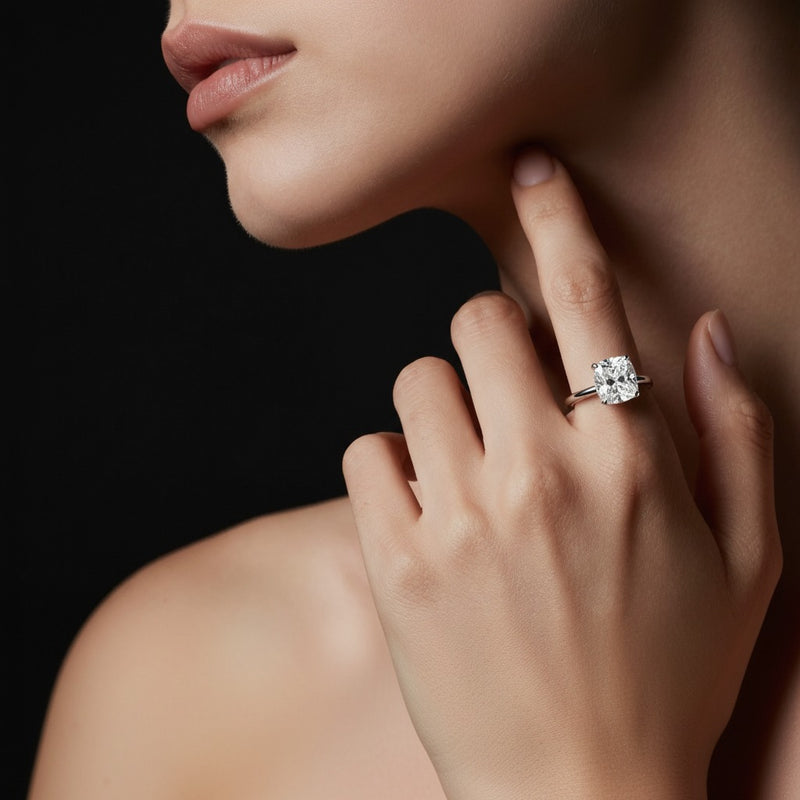 Model wearing cushion knife edge shank solitaire engagement ring