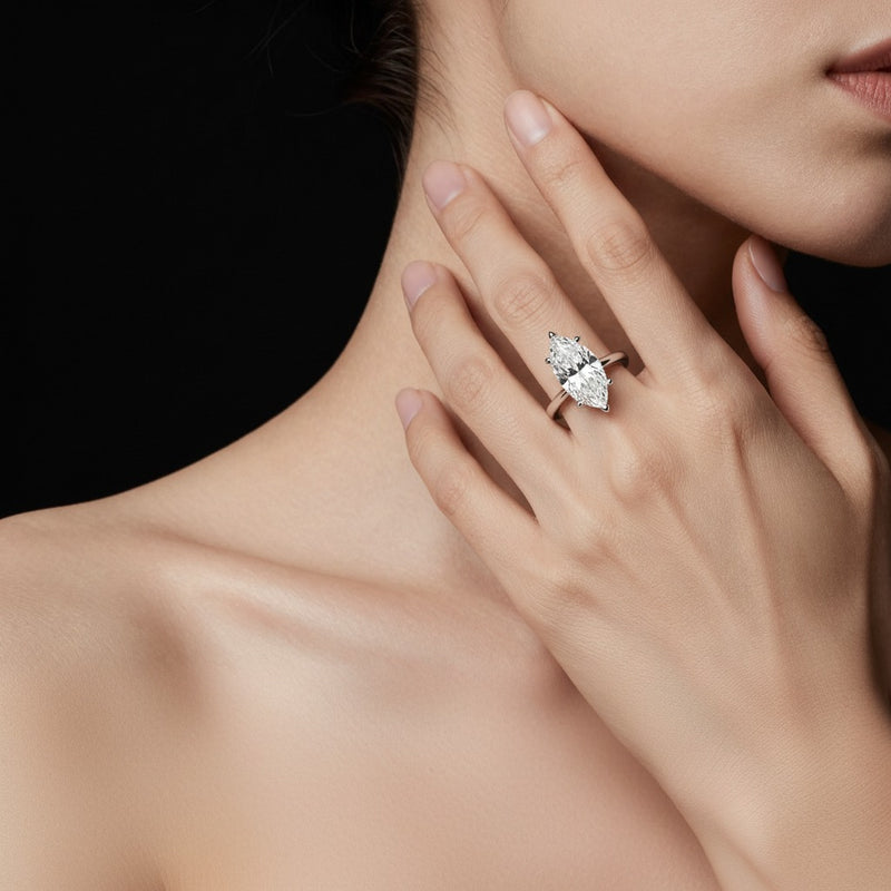 Model wearing marquise knife edge shank solitaire engagement ring