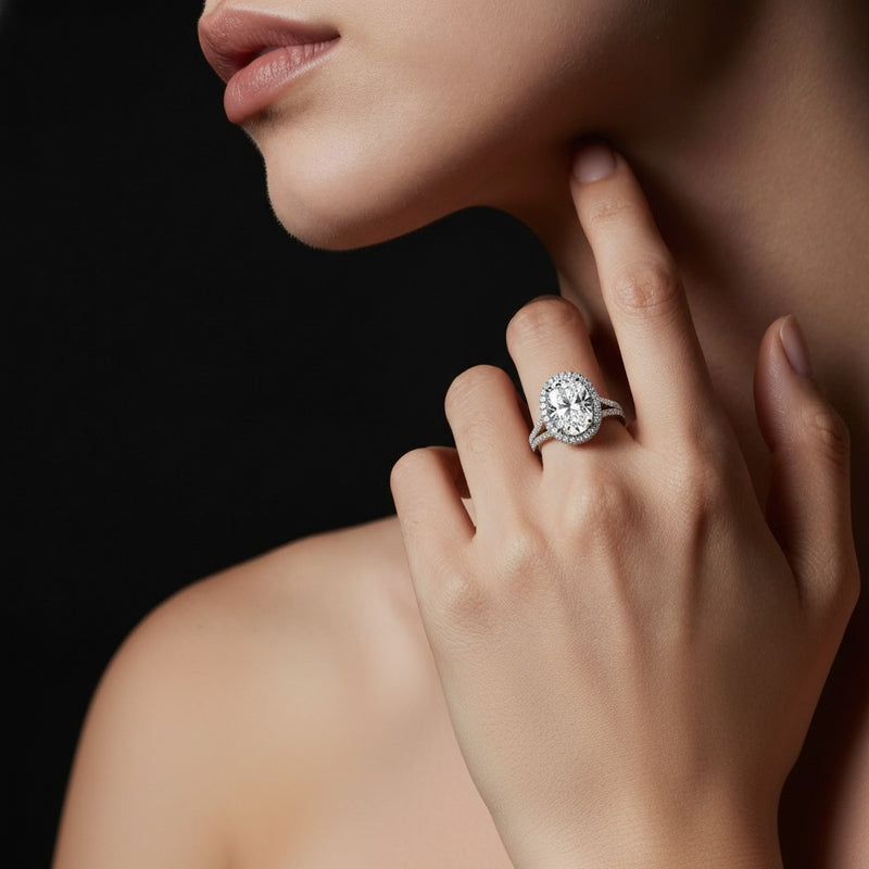 Model wearing oval halo accented engagement ring