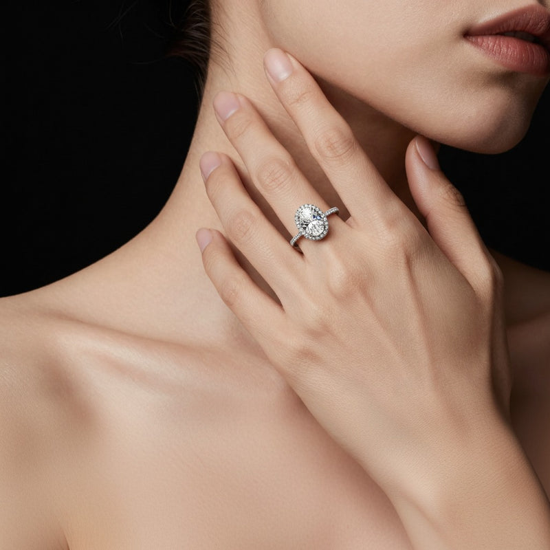 Model wearing oval halo accented engagement ring