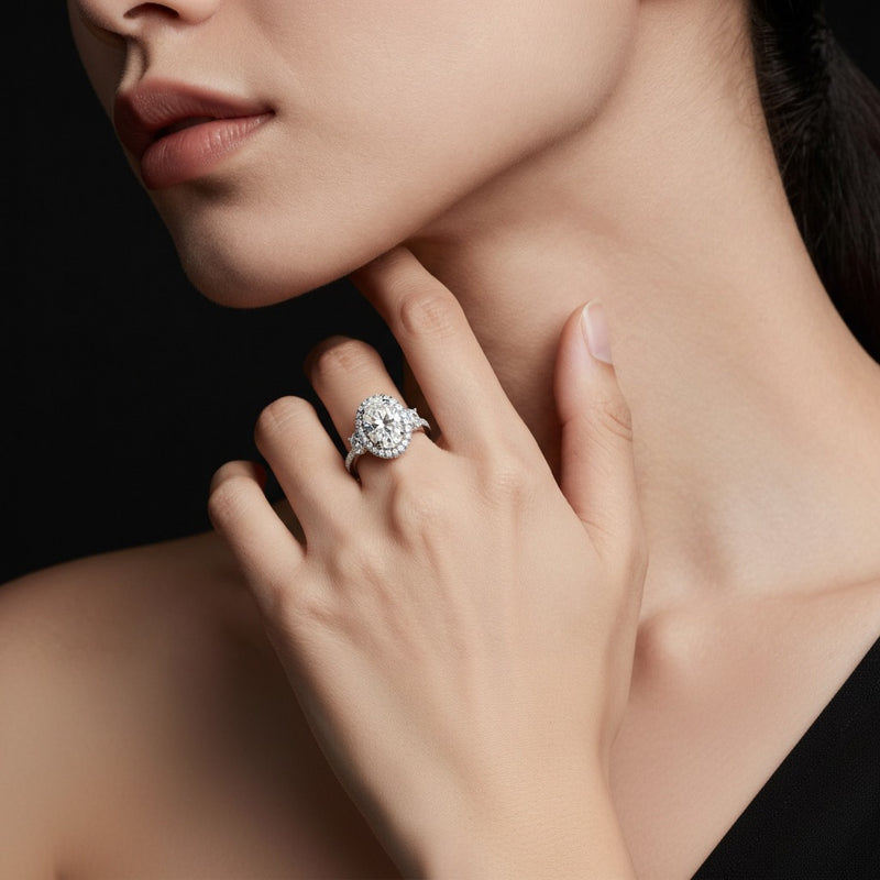 Model wearing oval three stone accented engagement ring