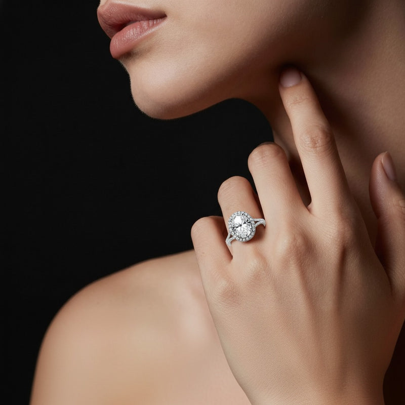 Model wearing oval halo accented engagement ring