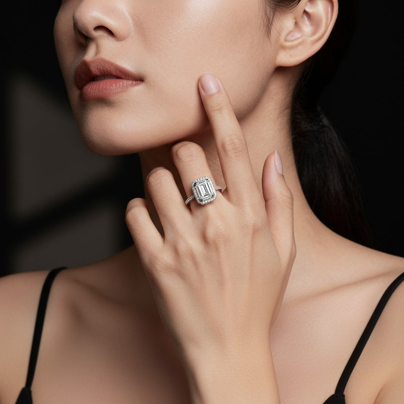 Model wearing emerald halo accented engagement ring