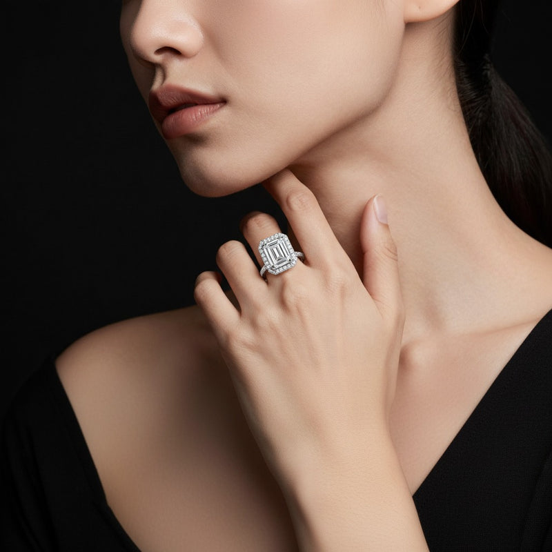 Model wearing emerald halo accented engagement ring