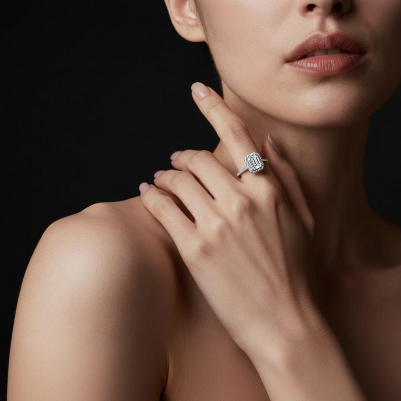 Model wearing emerald classic halo accented engagement ring