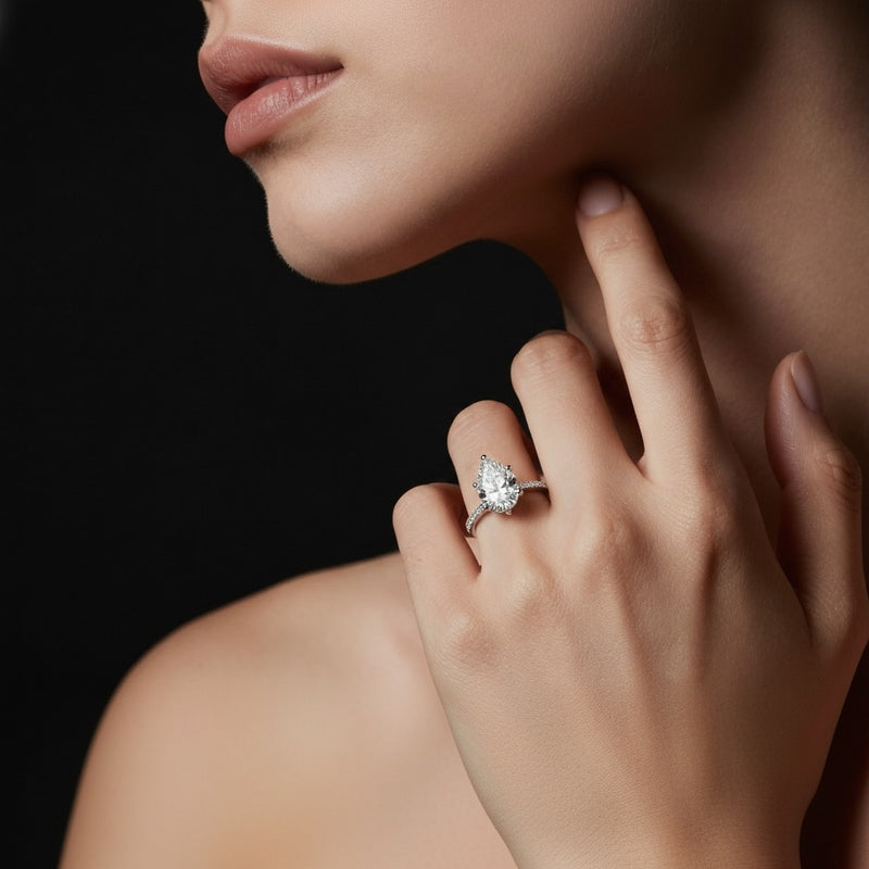 Model wearing pear tulip motif accented engagement ring