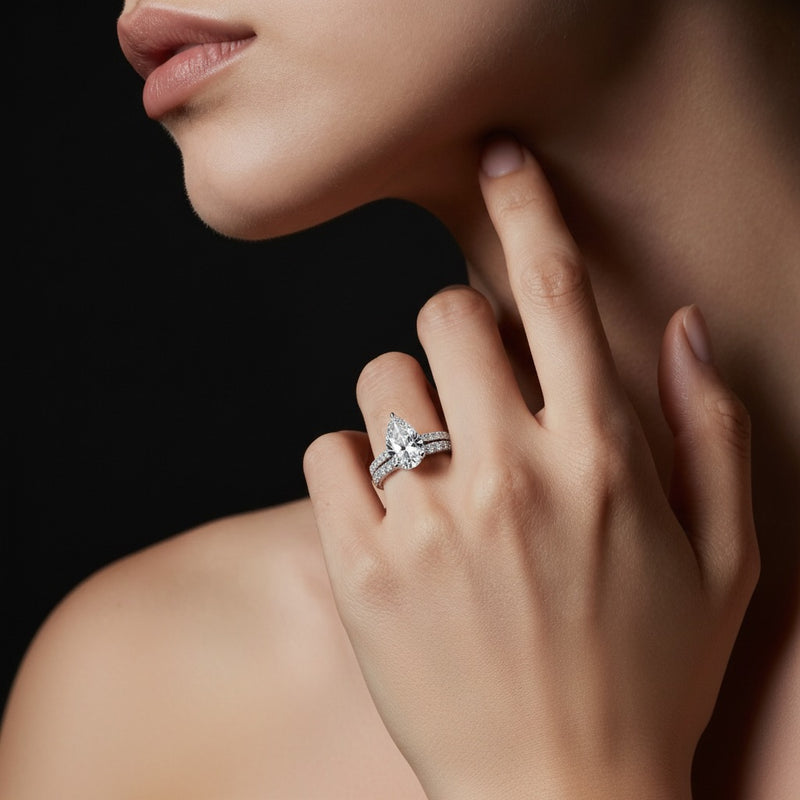 Model wearing pear classic accented set with band and engagement ring