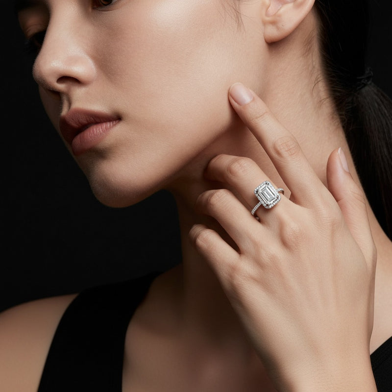 Model wearing emerald halo accented engagement ring