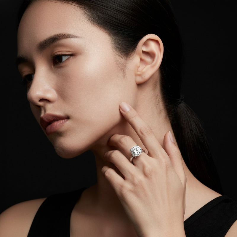 Model wearing round classic shank solitaire engagement ring