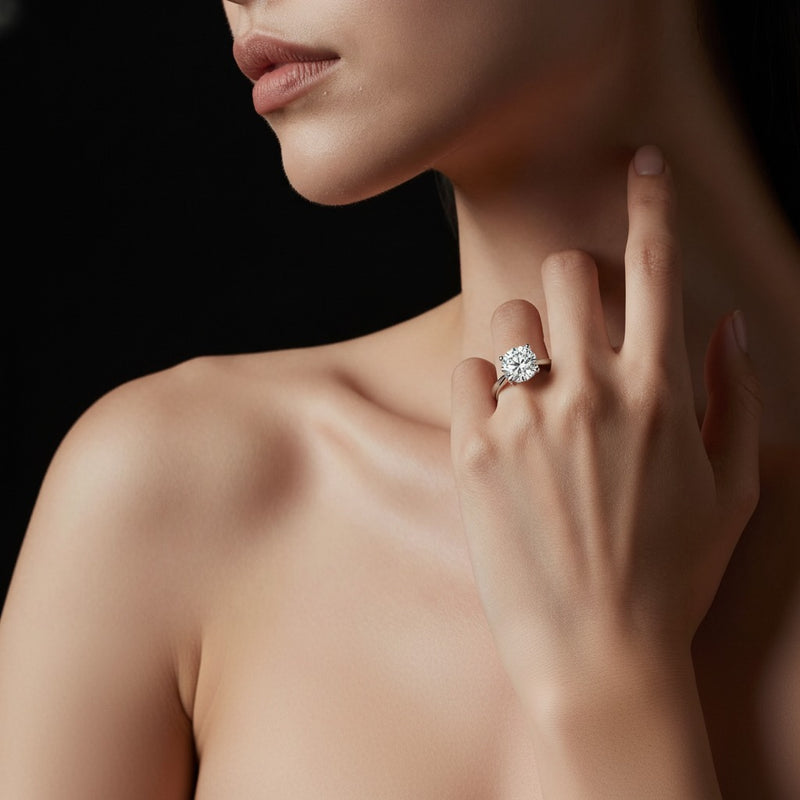 Model wearing round classic shank solitaire engagement ring