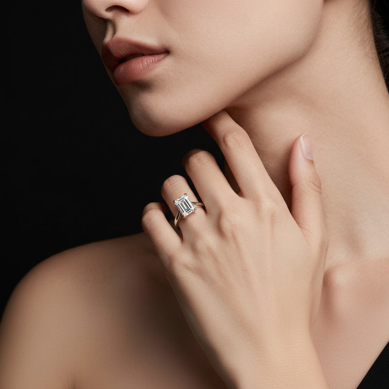 Model wearing emerald two tone cathedral shank engagement ring