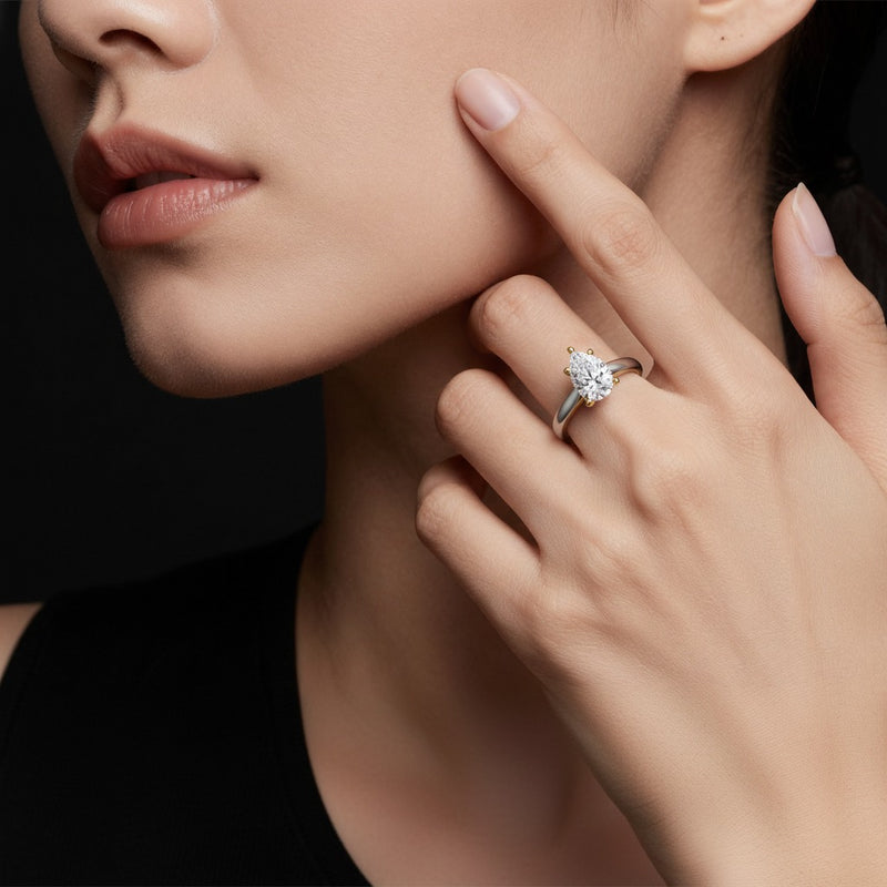 Model wearing pear two tone cathedral shank engagement ring