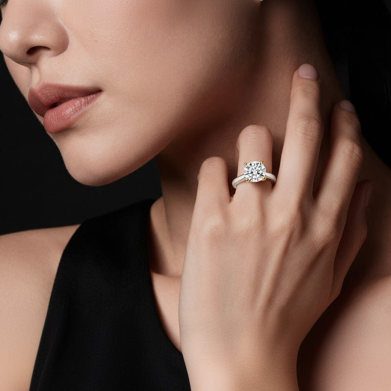 Model wearing round two tone cathedral shank engagement ring
