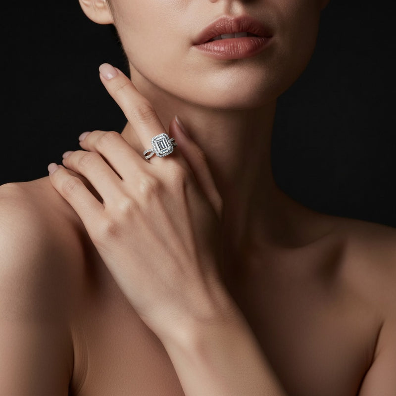 Model wearing emerald split shank halo accented engagement ring