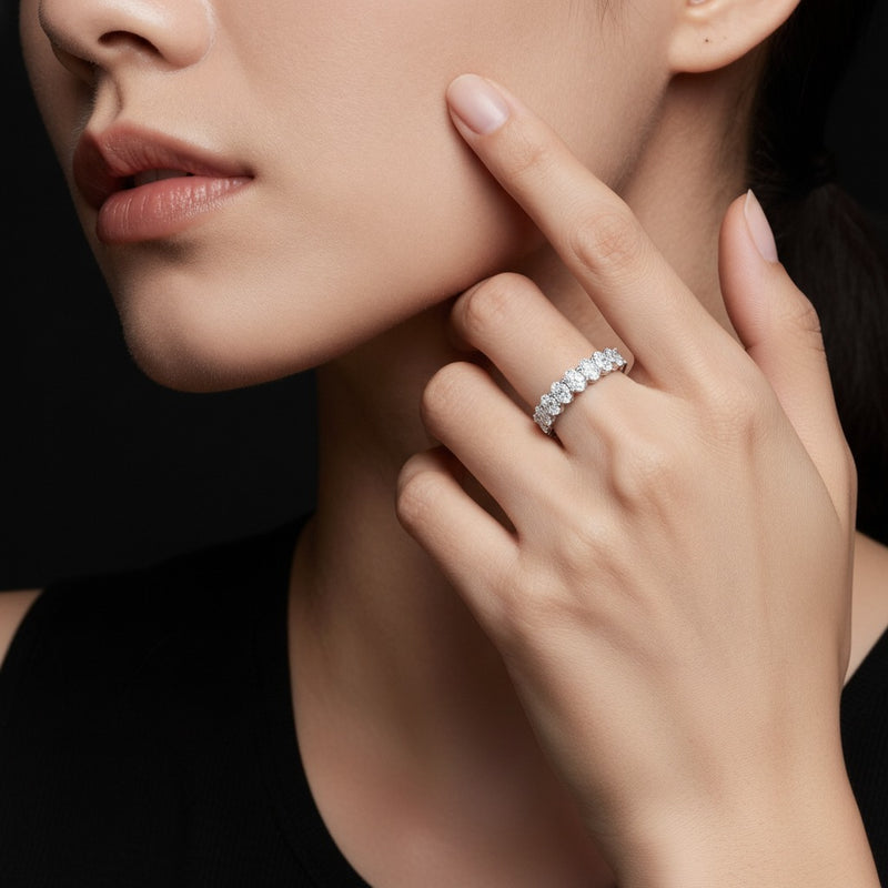 Model wearing oval seven stone band ring