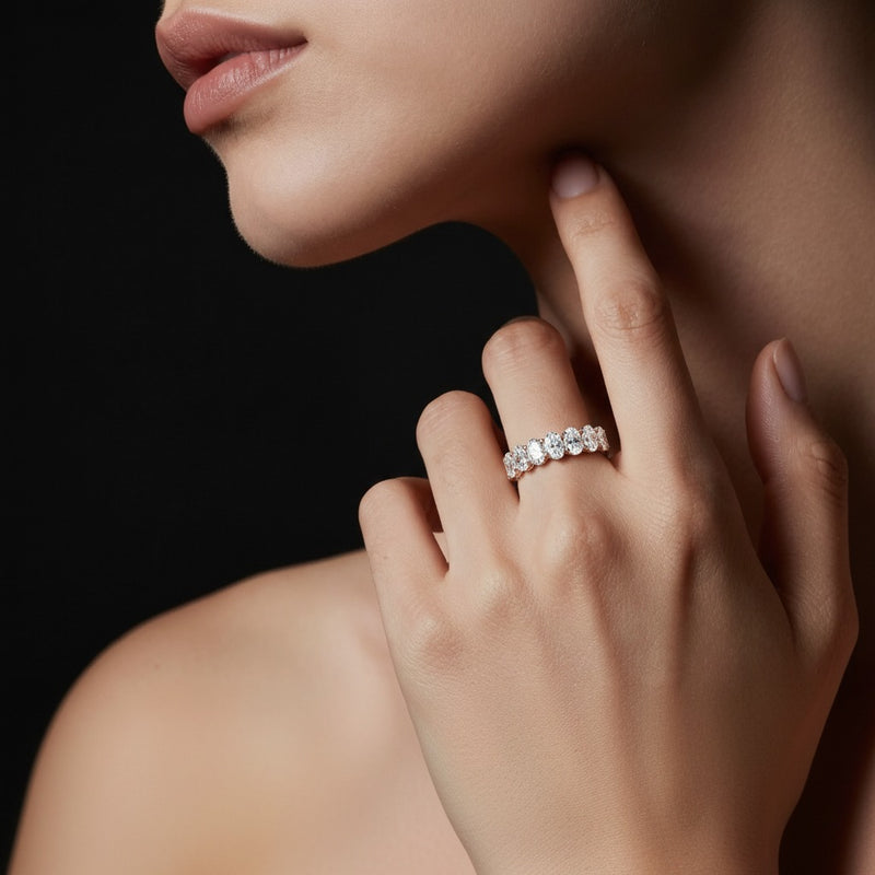 Model wearing oval seven stone band ring